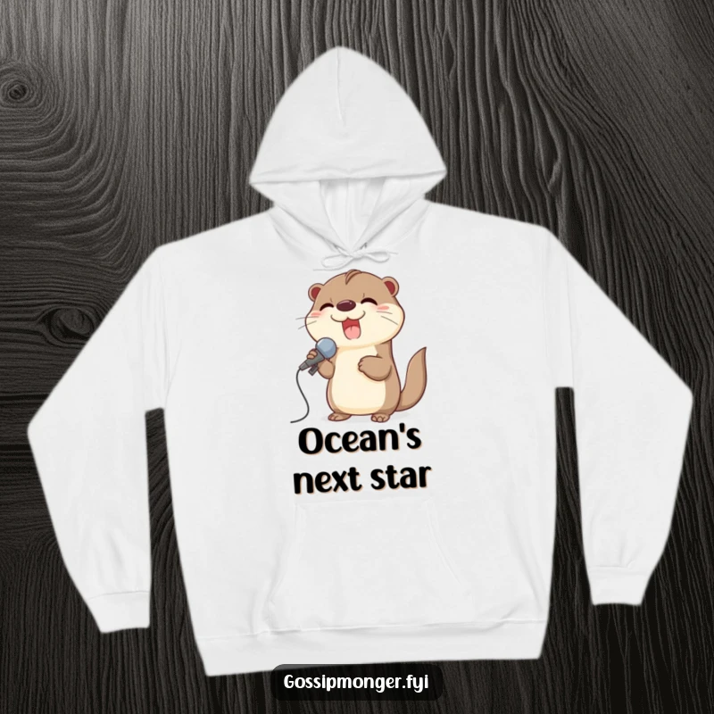 Funny hoodie of a giggling otter using a large seashell as a microphone, ready to perform a hit song.